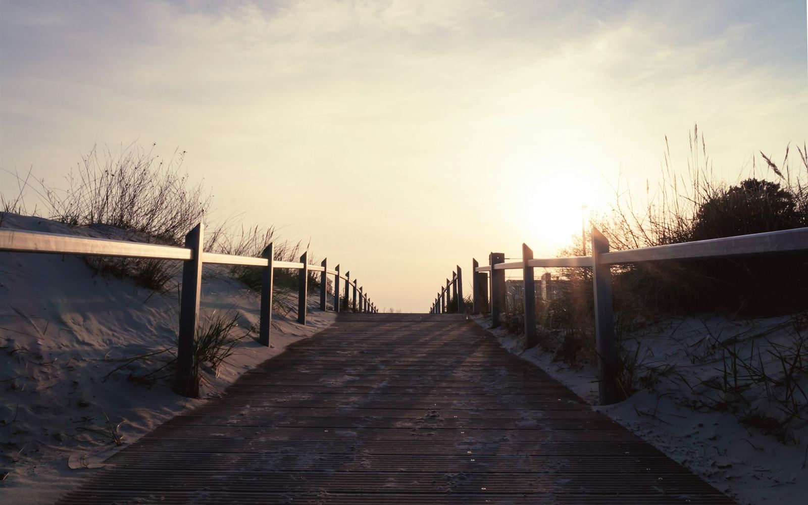 Wooden boardwalk through the dunes towards the sunrise, symbolising freedom from smoking and vaping